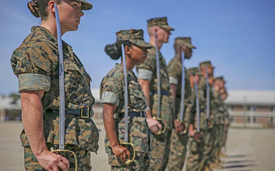 What are the logistical challenges of implementing a women's military draft?